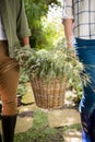 Mid-section of couple walking with flower basket