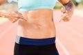 Mid section of female athlete pointing on her belly Royalty Free Stock Photo