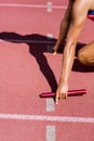 Mid-section of female athlete ready to start the relay race Royalty Free Stock Photo