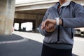 Female jogger using smartwatch on a sunny day