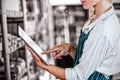 Female staff using digital tablet in supermarket Royalty Free Stock Photo