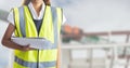 Mid section of female worker holding blue prints Royalty Free Stock Photo