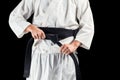 Mid section of fighter tightening karate belt