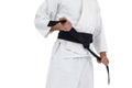 Mid section of fighter tightening karate belt