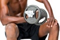Mid section of fit shirtless man lifting dumbbell Royalty Free Stock Photo