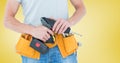 Mid-section of handy man with tool belt and drill Royalty Free Stock Photo