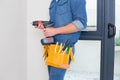 Mid section of a handyman with drill and toolbelt Royalty Free Stock Photo