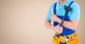 Mid section of handyman holding wrench and plunger with tool belt around his waist Royalty Free Stock Photo