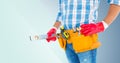 Mid section of handyman with tool belt and spirit level Royalty Free Stock Photo