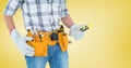 Mid section of handyman with tool belt and spirit level Royalty Free Stock Photo