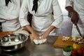 Mid section of head chef making pizza dough Royalty Free Stock Photo