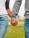 Mid section image of a couple holding hands