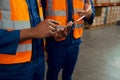 Mid section of two male employees holding digital tablet in manufacturing industry Royalty Free Stock Photo