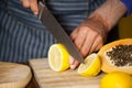 Mid-section of male staff cutting lemon in organic section Royalty Free Stock Photo