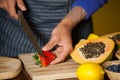 Mid-section of male staff cutting strawberry at organic section Royalty Free Stock Photo