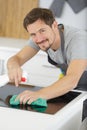 mid section man cleaning marble counter in kitchen Royalty Free Stock Photo