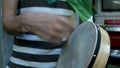 Mid section of man playing bodhran