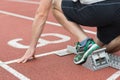 Mid section of a man ready to race on running track Royalty Free Stock Photo