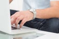 Mid section of a man using laptop on coffee table Royalty Free Stock Photo