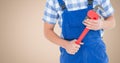 Mid section of mechanic holding pipe wrench Royalty Free Stock Photo