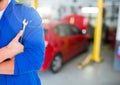 Mid section of mechanic holding wrench Royalty Free Stock Photo