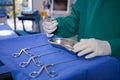 Mid section of surgeon holding surgical tool in operation theater Royalty Free Stock Photo