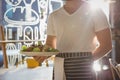 Mid section of waiter holding plate with salad in cafe