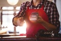 Mid section of waiter showing credit card machine