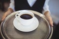 Mid-section of waitress holding tray with black coffee Royalty Free Stock Photo