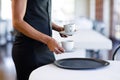 Mid section of waitress serving cup of coffee Royalty Free Stock Photo