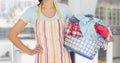 Mid section of woman with apron holding a laundry basket Royalty Free Stock Photo