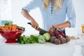 Mid-section of woman cutting vegetables on chopping board Royalty Free Stock Photo