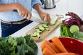 Mid-section of woman cutting vegetables on chopping board Royalty Free Stock Photo