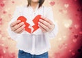 Mid-section of a woman holding a broken heart Royalty Free Stock Photo