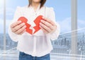 Mid-section of woman holding a broken heart Royalty Free Stock Photo