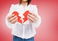 Mid-section of a woman holding a broken heart Royalty Free Stock Photo