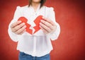 Mid section of woman holding a broken heart Royalty Free Stock Photo