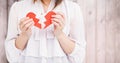 Mid-section of woman holding a broken heart Royalty Free Stock Photo