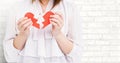 Mid-section of woman holding two broken hearts Royalty Free Stock Photo
