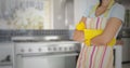 Mid section of woman standing with arms crossed in kitchen Royalty Free Stock Photo