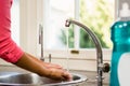 Mid section of woman washing hands