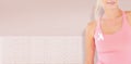 Composite image of mid section of woman wearing breast cancer awareness ribbon Royalty Free Stock Photo