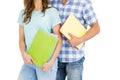 Mid section of young couple holding book and folder