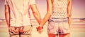 Mid section of young couple holding hands at beach Royalty Free Stock Photo