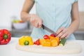 Mid section of young slender woman cutting vegetables Royalty Free Stock Photo