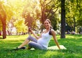 Pregnant woman drinking water in park Royalty Free Stock Photo