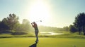 A Mid-Swing Golfer Silhouette Against a Vibrant Green Golf Course Under a Clear Blue Sky Royalty Free Stock Photo