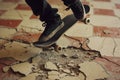 midaction shot of kickflip over a floor crack with chipped tiles Royalty Free Stock Photo