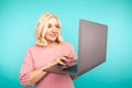 Midage woman with laptop isolated check her mail and typing. Royalty Free Stock Photo