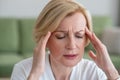 Midaged blone woman suffering from a headache Royalty Free Stock Photo